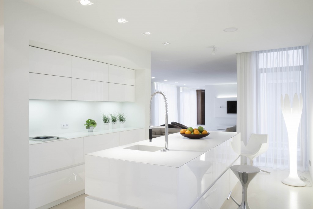 White clean kitchen with island in the middle